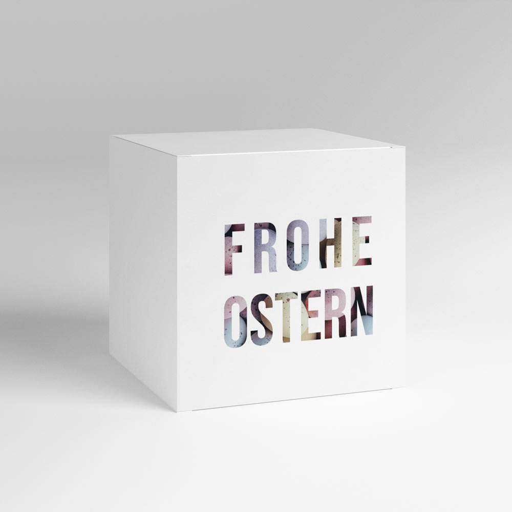 Weiße Box mit bunter Aufschrift "Frohe Ostern"